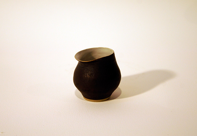 Artwork: Small matt black jug with white interior